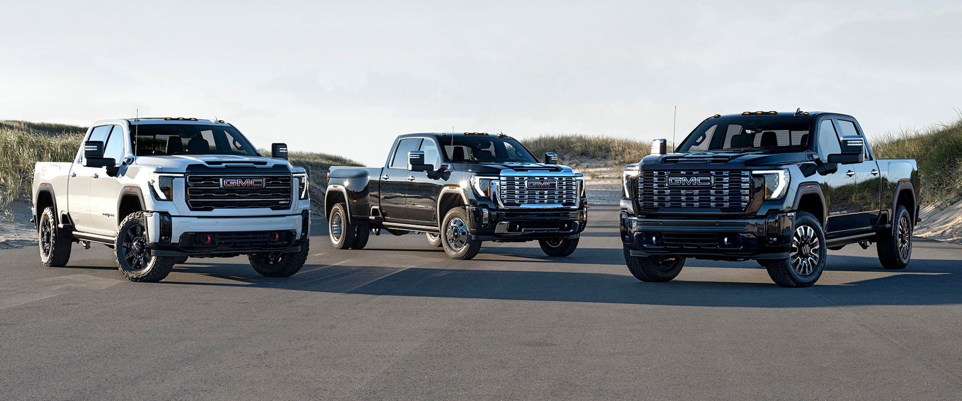 Photograph of three 2025 GMC Sierra 2500HD Trucks